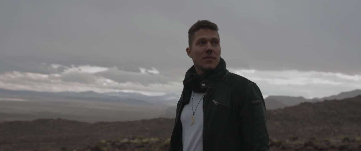 Man stands in nature looking around