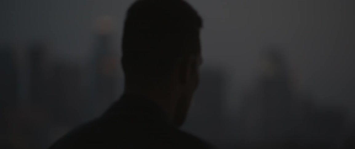 A man walks out in a dark area