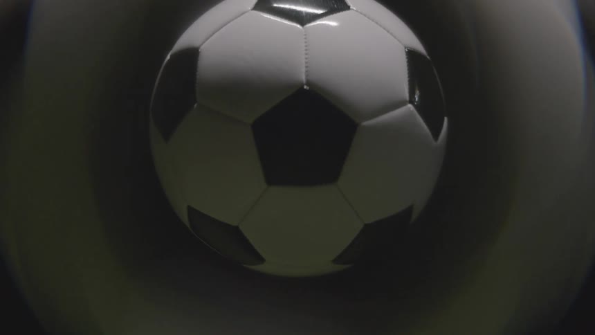 Soccer ball appears enlarged and softly distorted in closeup