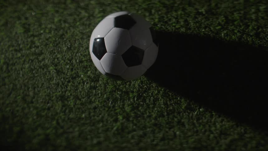 Black and white soccer ball on synthetic grass