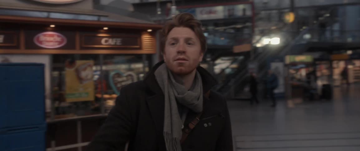 Man waiting to greet someone in a mall
