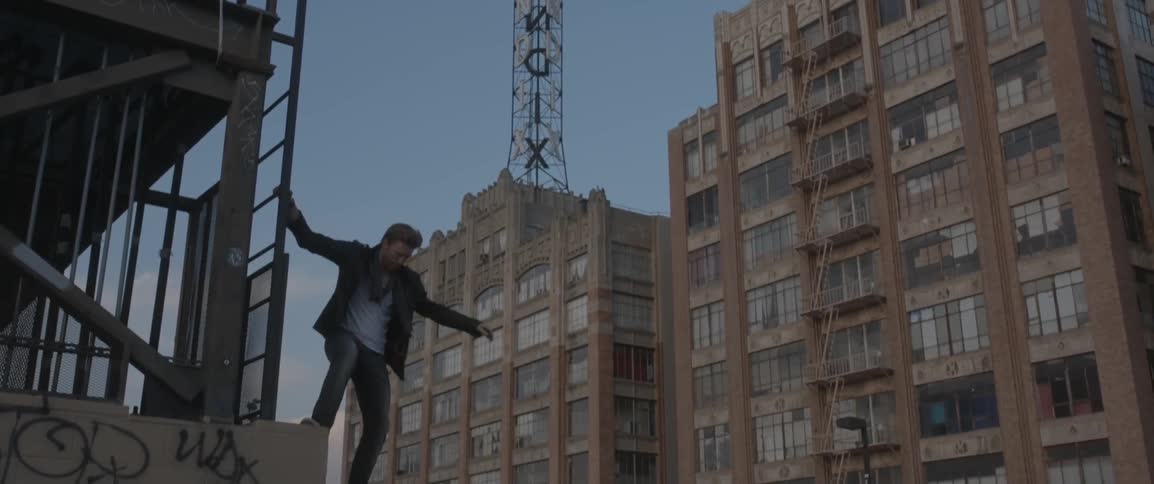 A man climbs down the side of a ladder