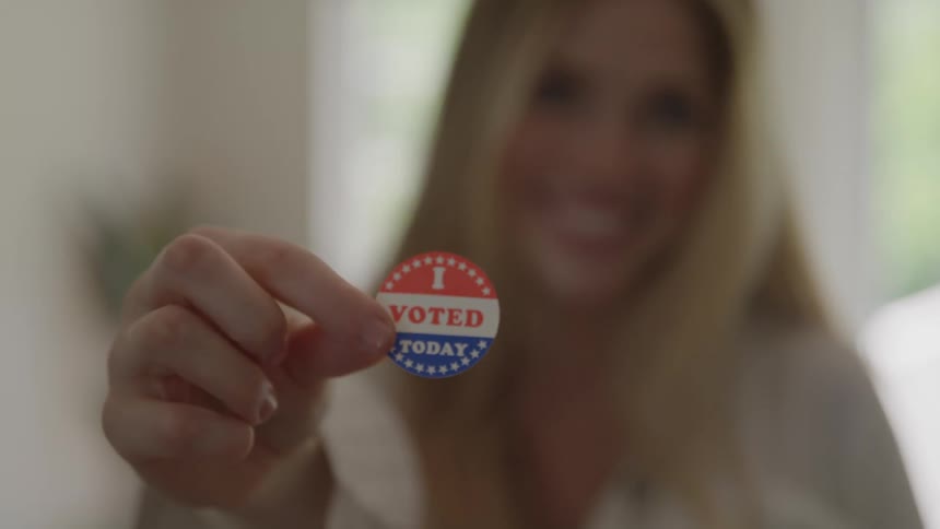 Woman holding i voted today sticker