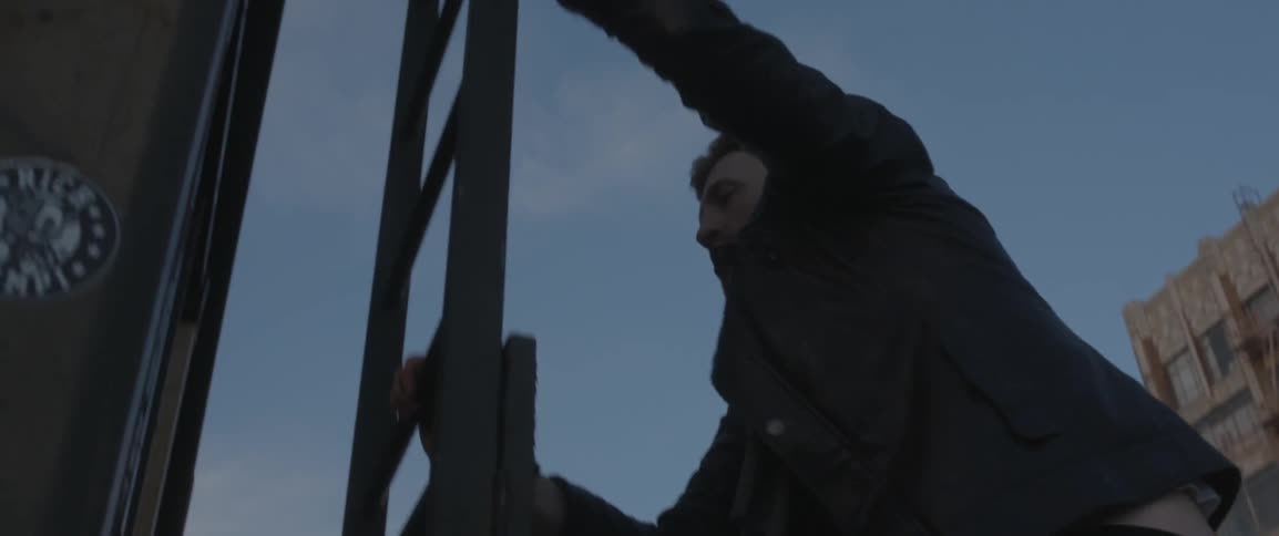 A man climbs up a steel ladder