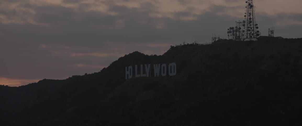 The hollywood sign sits below a cloudy sign