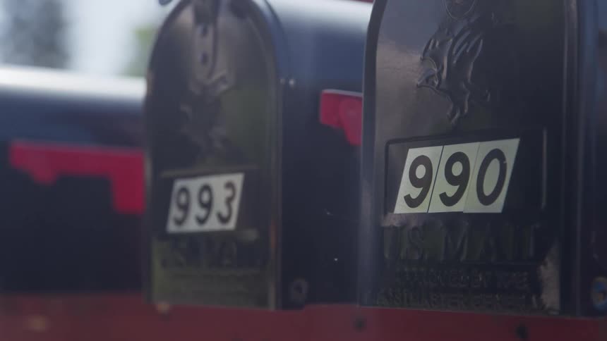 Black mailboxes side by side labeled 993 and 990