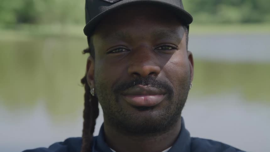 A portrait of a man standing outdoors