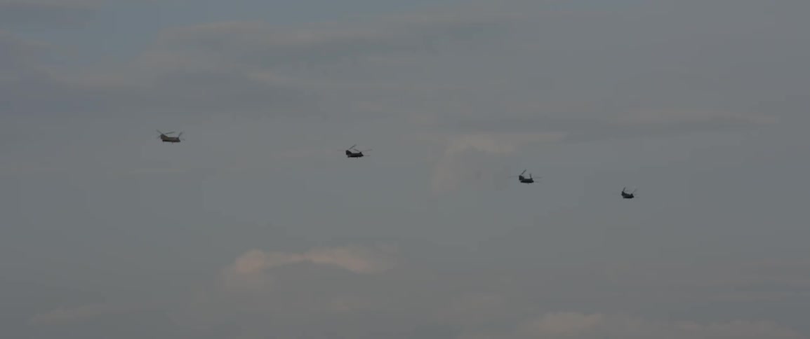 Helicopters fly in the sky