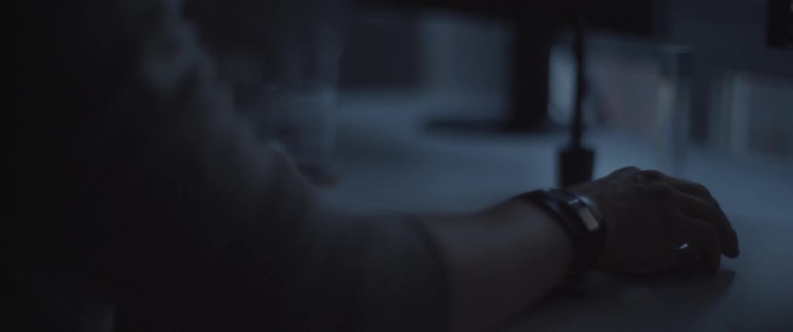 A man is using a keyboard in a dark room