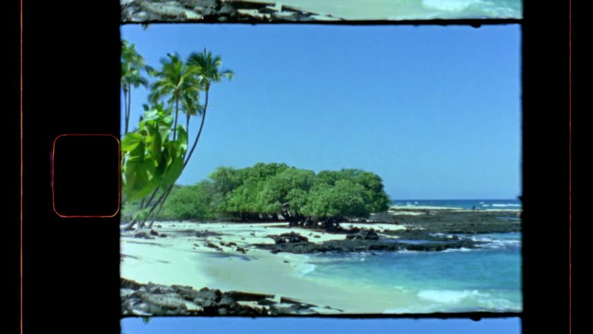 Tropical beach with white sand volcanic rocks and palm trees framed by film border
