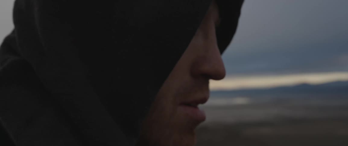 A man looks around over a field