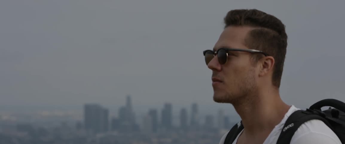 A man looks up slowly over a skyline