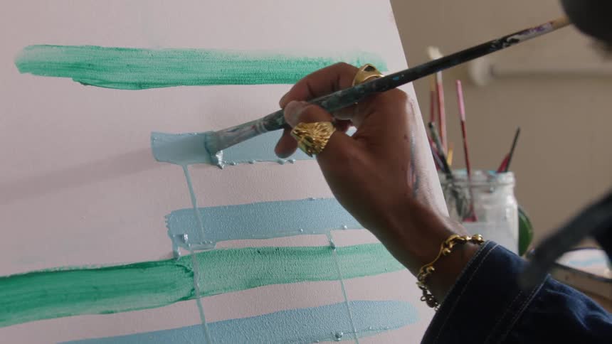 A person painting on a canvas
