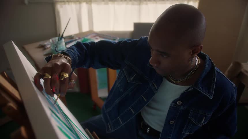 A man painting on a canvas