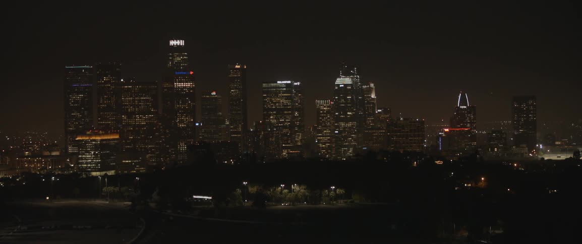 A night view of buildings in a city with lights