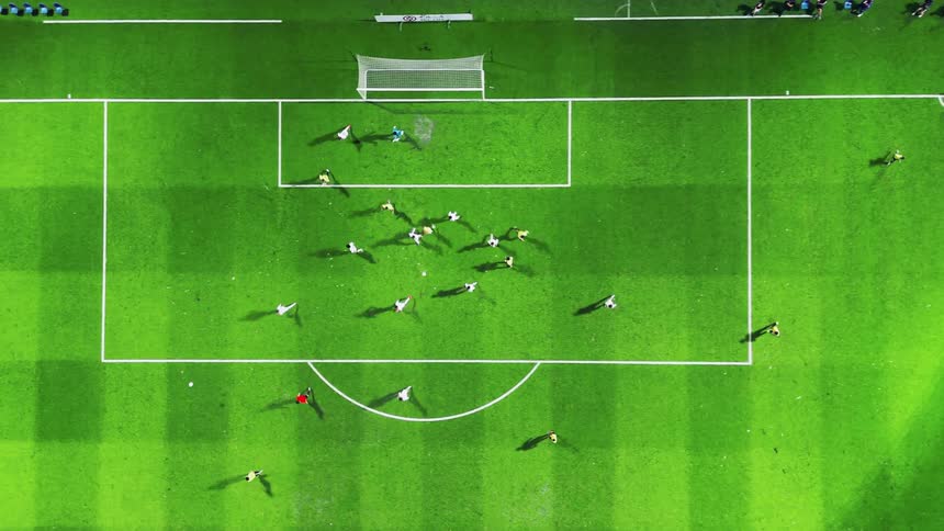 Soccer players on the field playing football at night