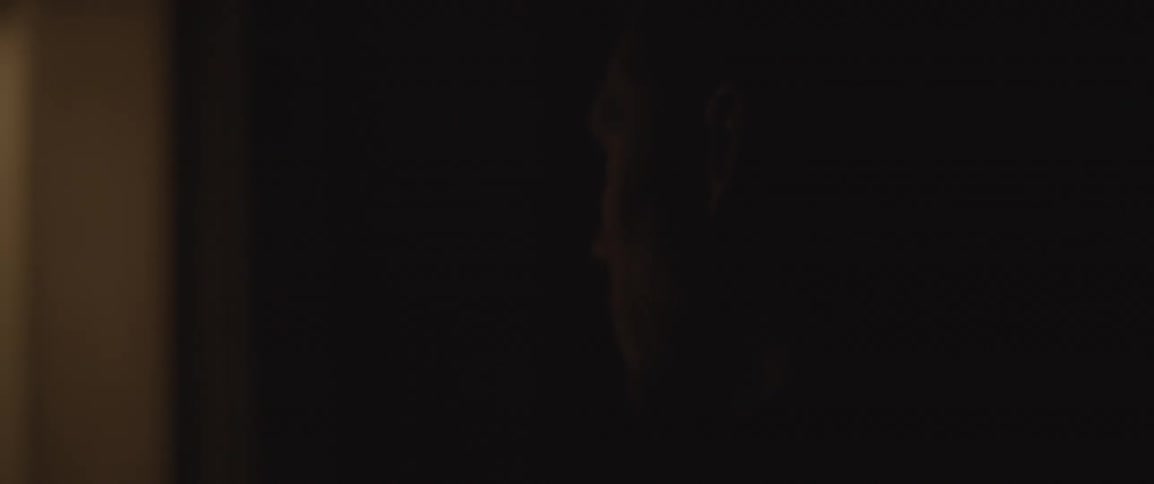 Lights flicker on and off while a man opens a door and exits the room