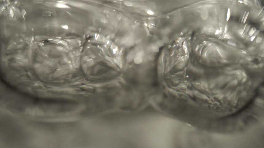 Boiling water reveals intense bubble motion on agitated surface and fluid texture