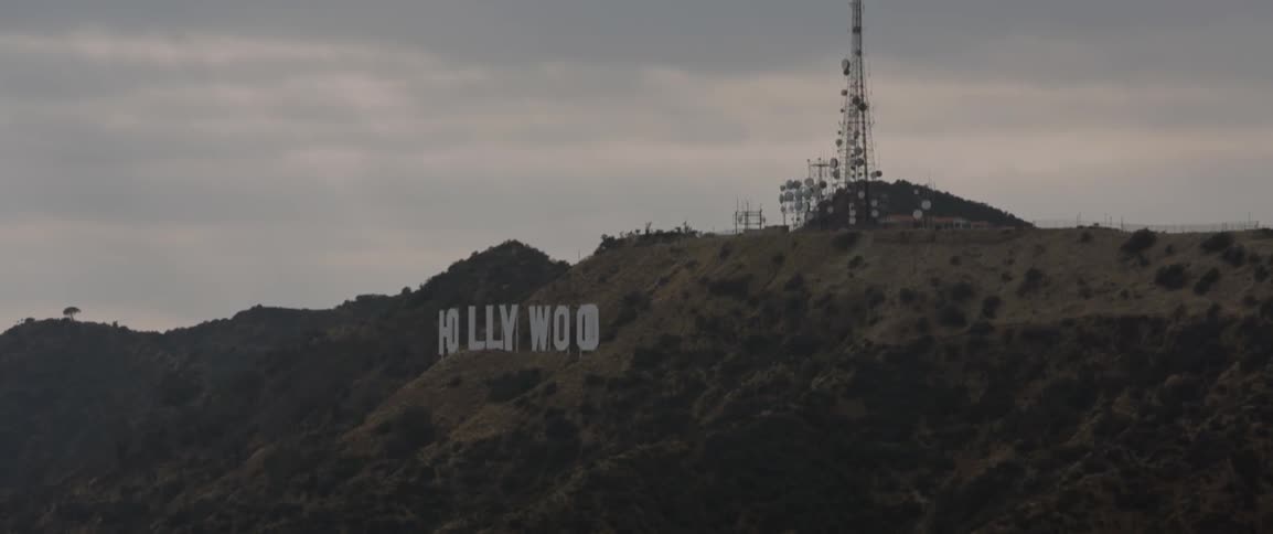 Radio towers stand above the hollywood sign
