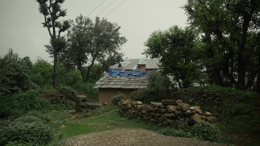 A rural house has temporary repairs on the roof