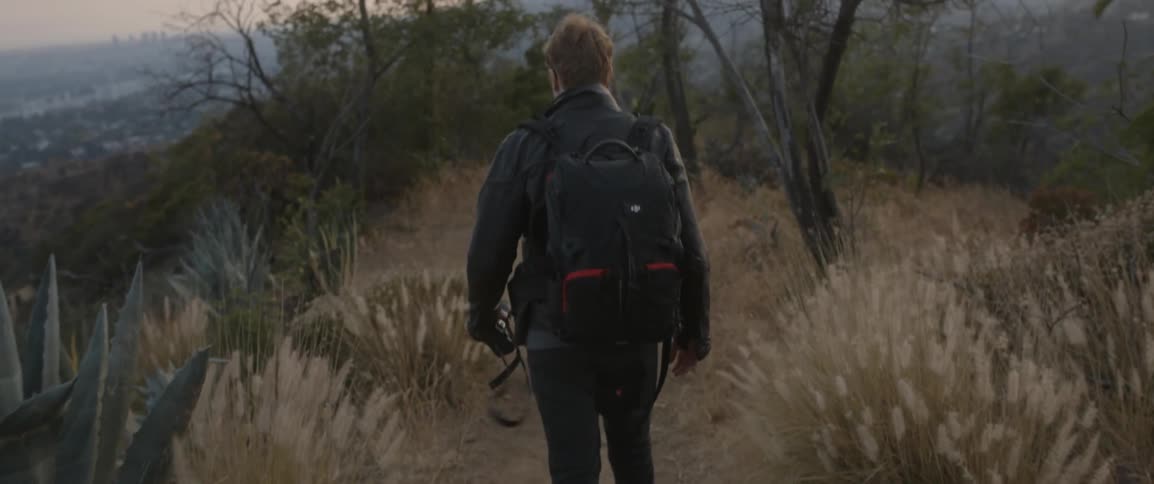 A man is hiking with a camera