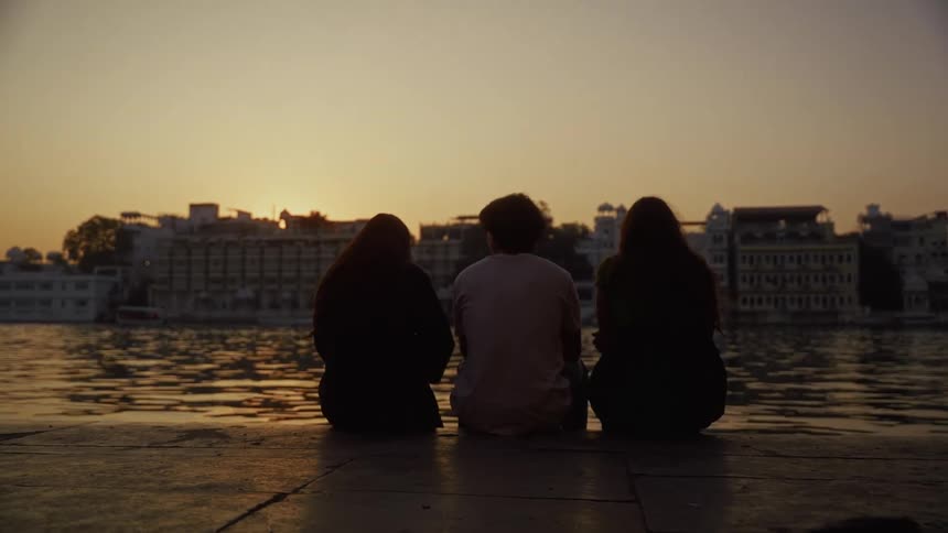 Three people sitting outdoors