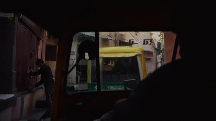 Narrow urban street seen from inside rickshaw