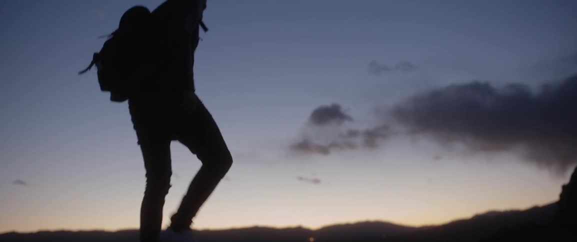 A man is hiking outside at dawn