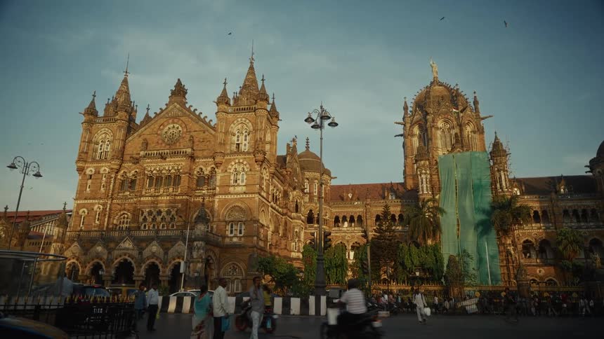 Chhatrapati shivaji maharaj station displays victorian gothic architecture with traffic and facade repairs