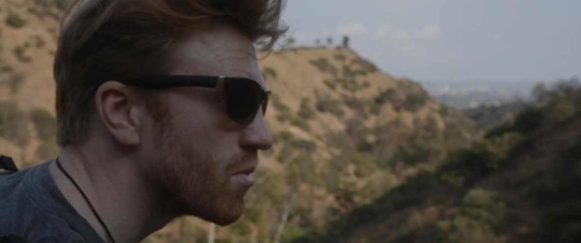 A man looks out over the hills