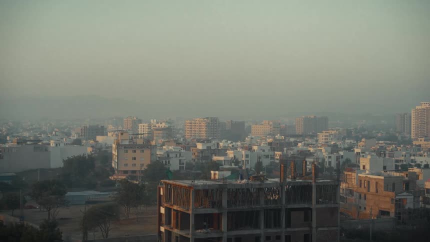 Urban buildings under light haze at dusk