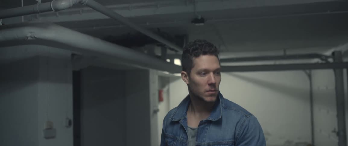 A man walking in a dark basement and the light turns on