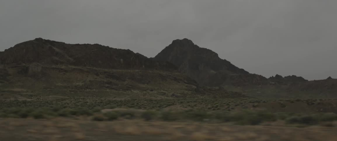 A desert area is seen from a moving vehicle