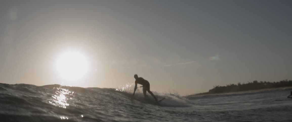 Man surfs on waves and falls in the water