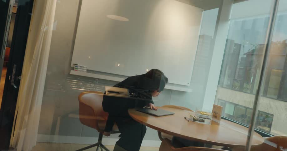 Woman sits down and works on her laptop