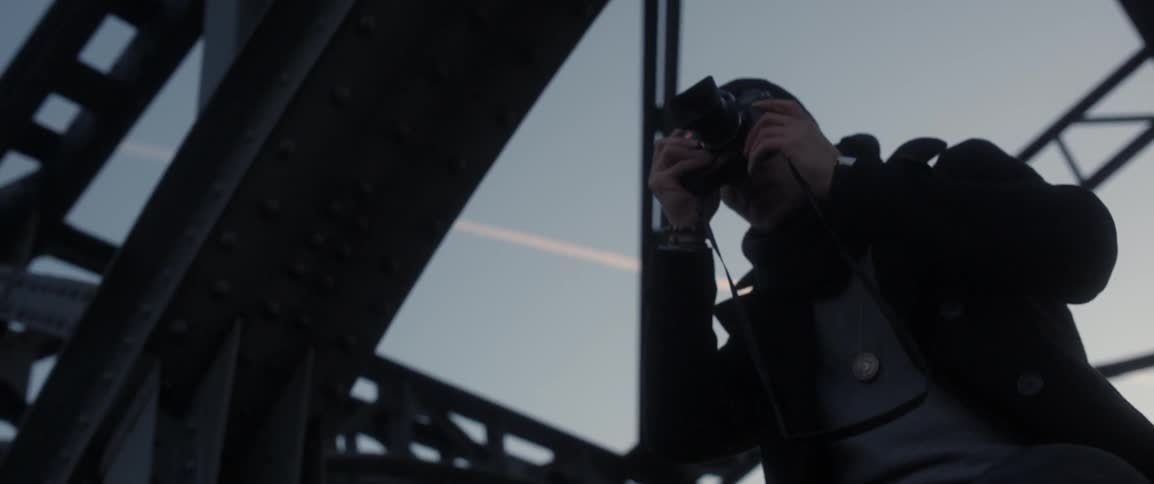 A man pulls his camera out to take a photograph