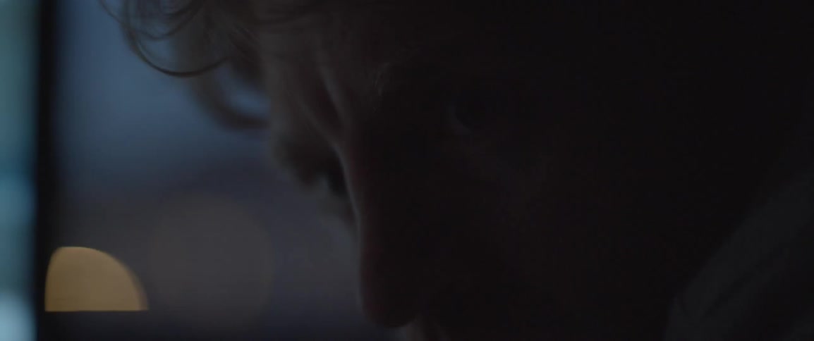 A man with lights flashing in his face