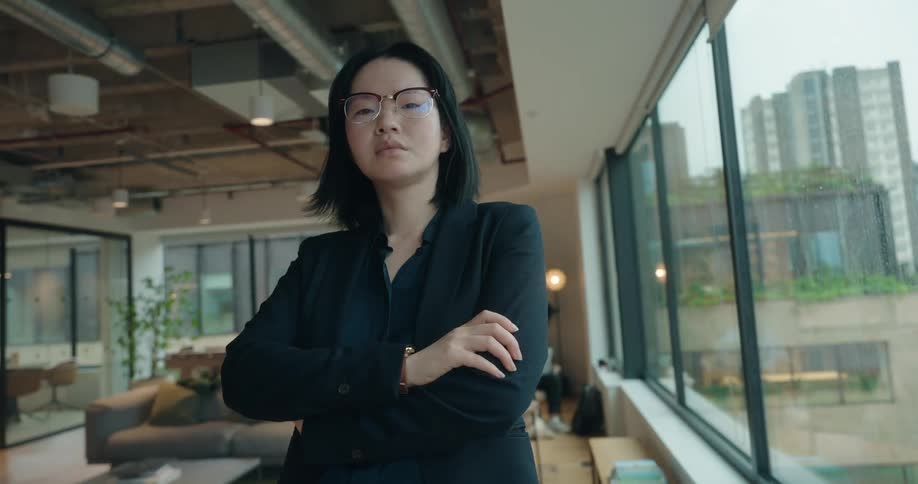 Woman with arms crossed in a modern office setting