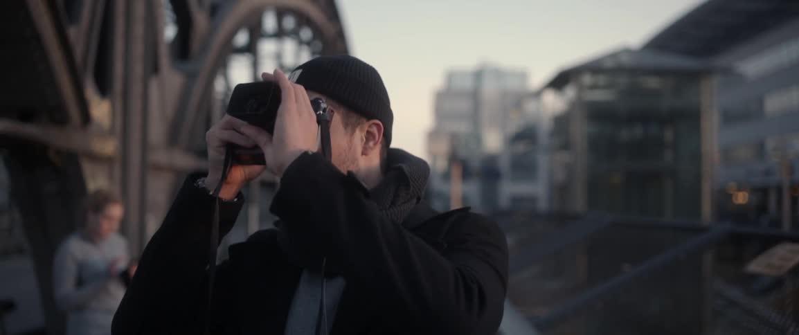 A man is taking photographs with a camera