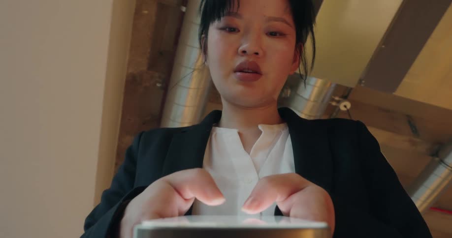 Woman types on her smartphone from a low angle