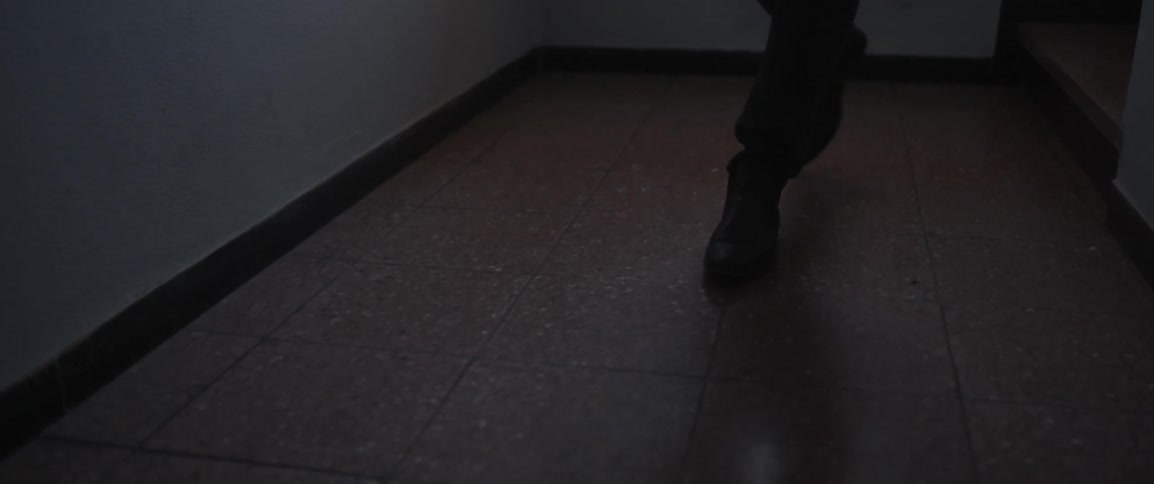 Person walks down a hallway at night