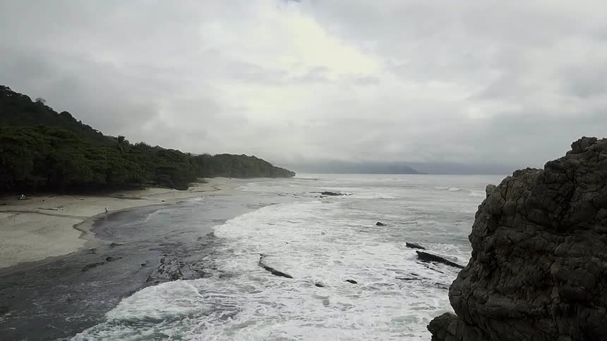 Waves rolling onto shore on a cloudy day