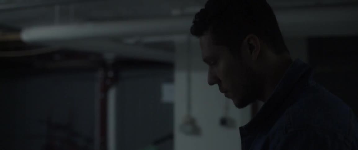 A man walks through a dark room
