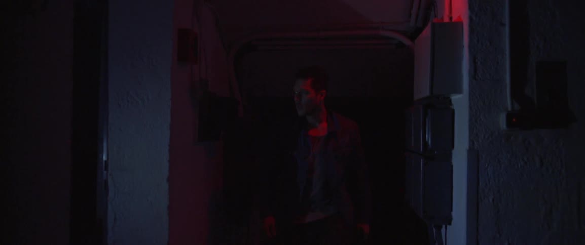 Lights flash on and off as a man walks down a hallway