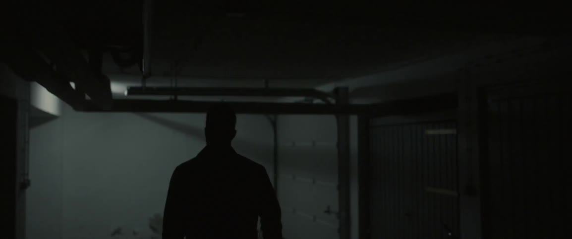 Man walking down a dark hallway