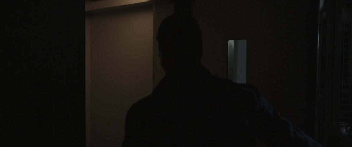 A man opens a door and walks in from outside