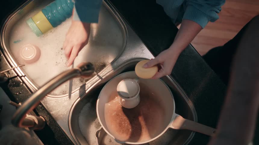 Two people washing dishes