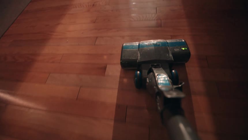 The vacuum is being used to clean the flooring