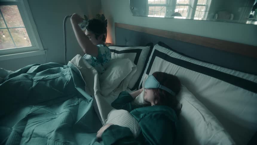A man and woman laying in a bed together