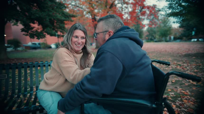 A man and woman kissing outdoors